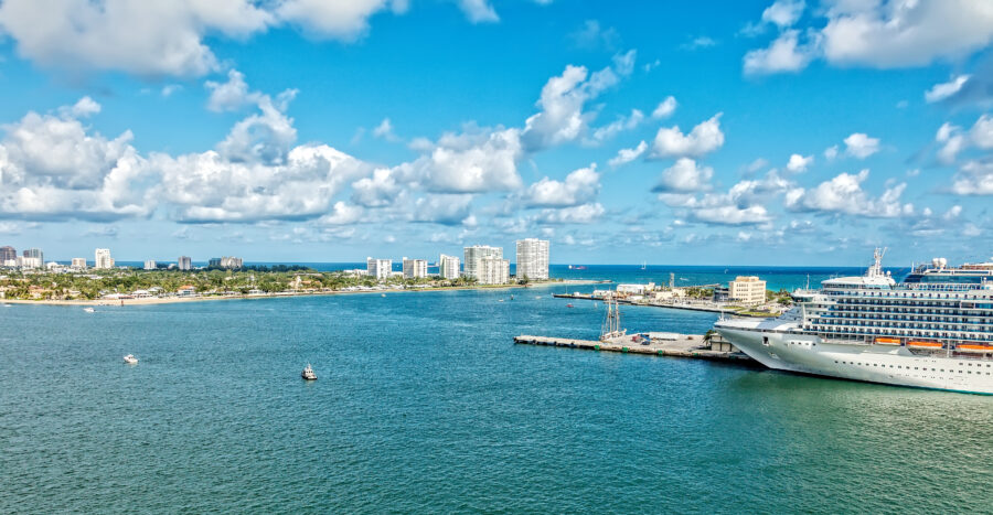 Aerial shot of cruise ship docked at Port Everglades in Fort Lauderdale. Skyline in the background.
